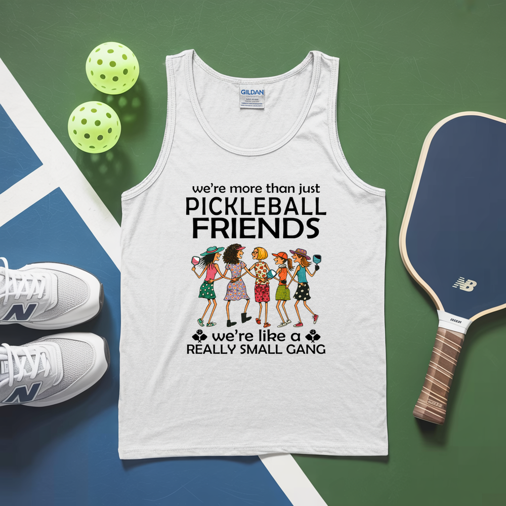 White tank top with pickleball-themed design on a green and blue surface with pickleballs and a paddle.