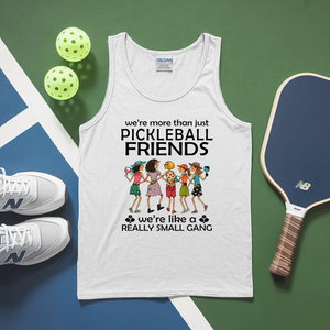 White tank top with pickleball-themed design on a green and blue surface with pickleballs and a paddle.