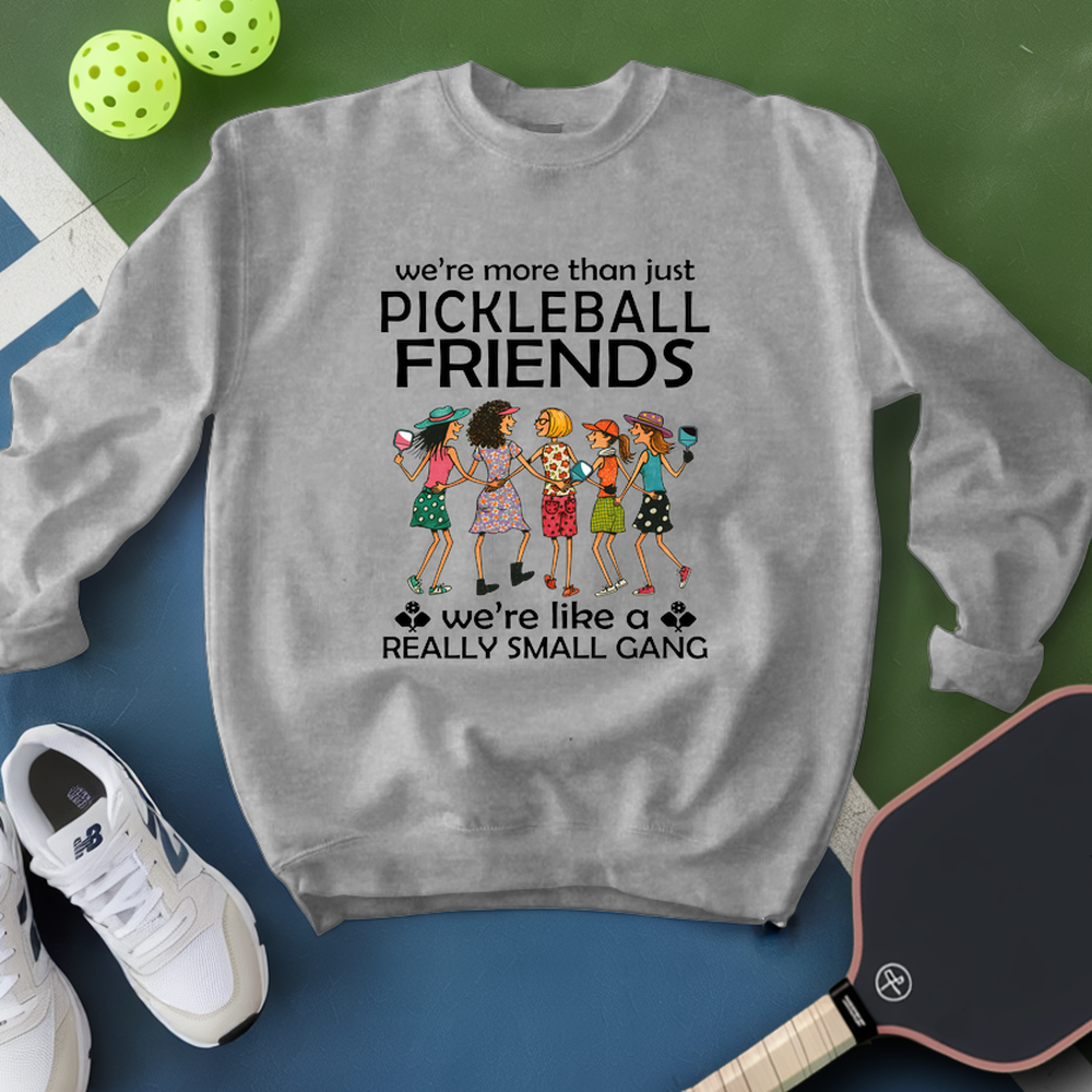 Gray sweatshirt with pickleball-themed design on a green and blue background