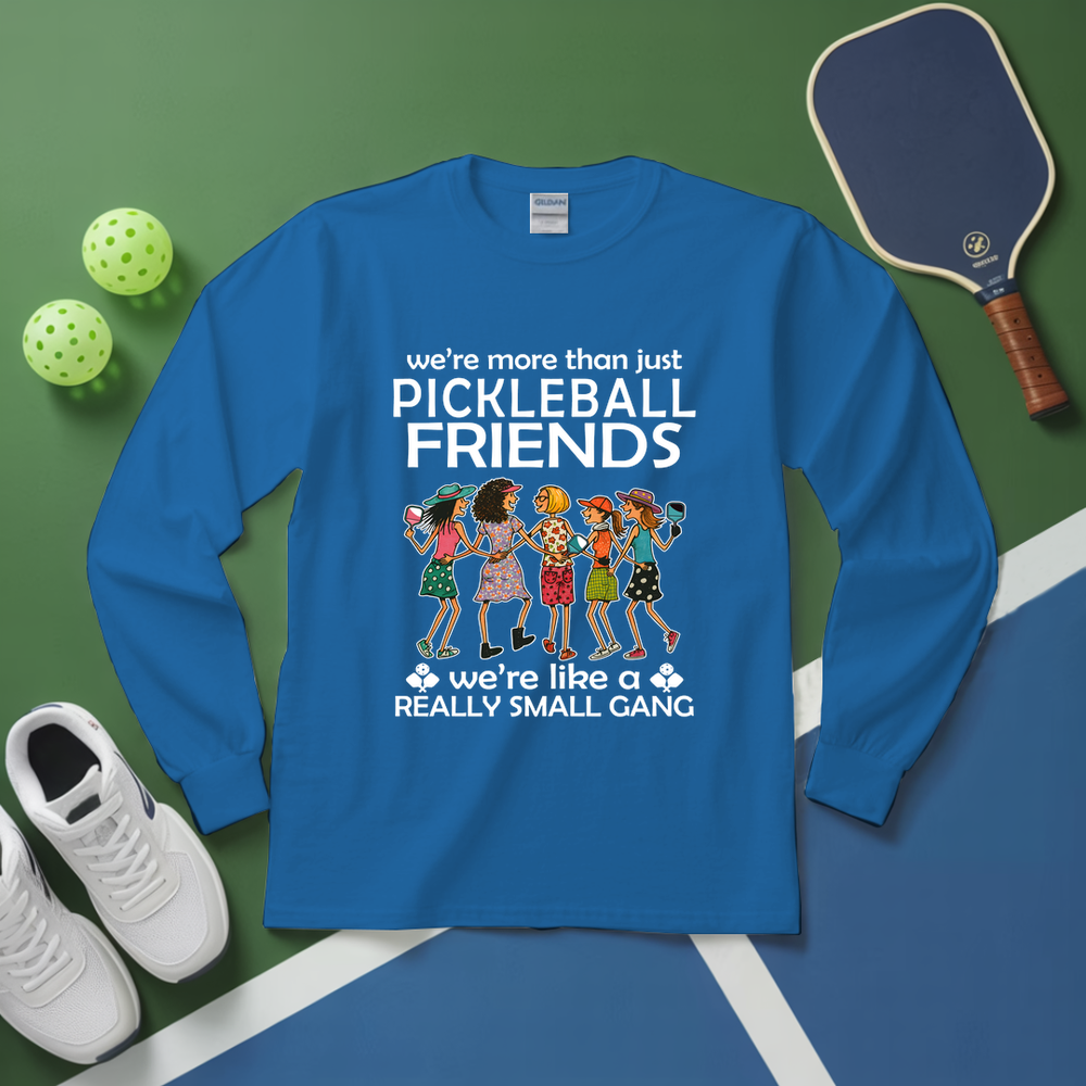 Blue long-sleeve shirt with pickleball-themed design on a green and blue background with pickleballs and a paddle.