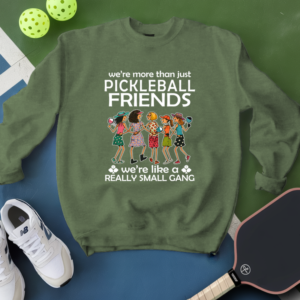 Green sweatshirt with pickleball-themed design on a blue and green background