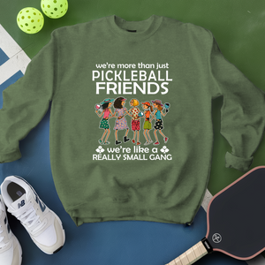 Green sweatshirt with pickleball-themed design on a blue and green background
