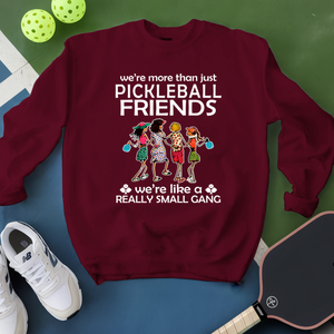 Maroon sweatshirt with pickleball-themed design on a blue and green background