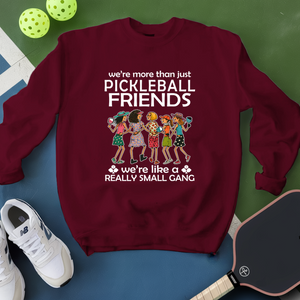 Maroon sweatshirt with pickleball-themed design on a green and blue background