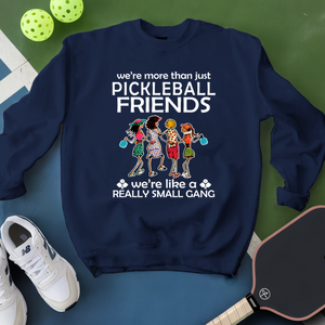 Navy blue sweatshirt with pickleball-themed design on a green and blue surface with pickleballs and a paddle.