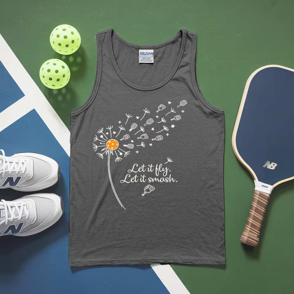 Gray tank top with dandelion graphic and text, placed on a green and blue surface with pickleballs and a paddle.