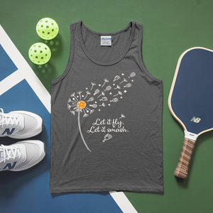 Gray tank top with dandelion graphic and text, placed on a green and blue surface with pickleballs and a paddle.