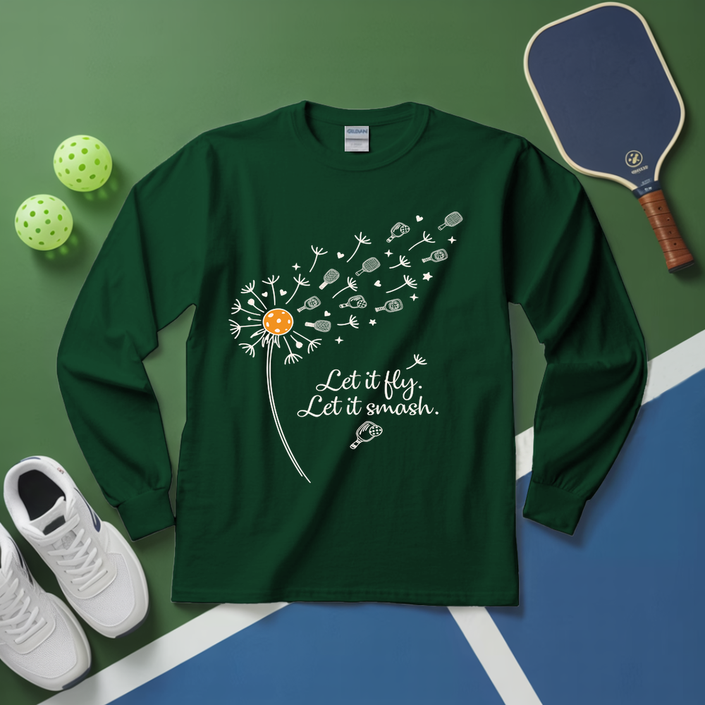 Green long-sleeve shirt with dandelion graphic and text on a green and blue surface with sports equipment.