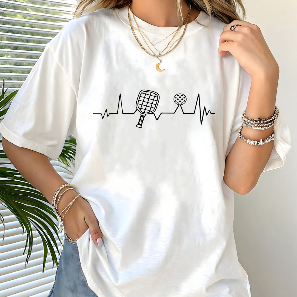 Person wearing a white t-shirt with a unique design, standing indoors.