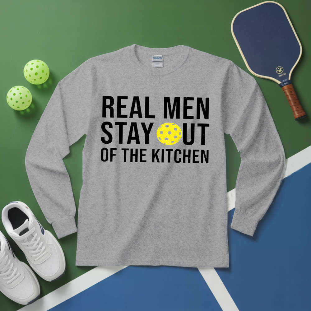 Gray long-sleeve shirt with 'Real Men Stay Out of the Kitchen' text and pickleball equipment on a green and blue background