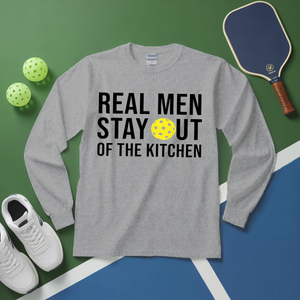 Gray long-sleeve shirt with 'Real Men Stay Out of the Kitchen' text and pickleball equipment on a green and blue background