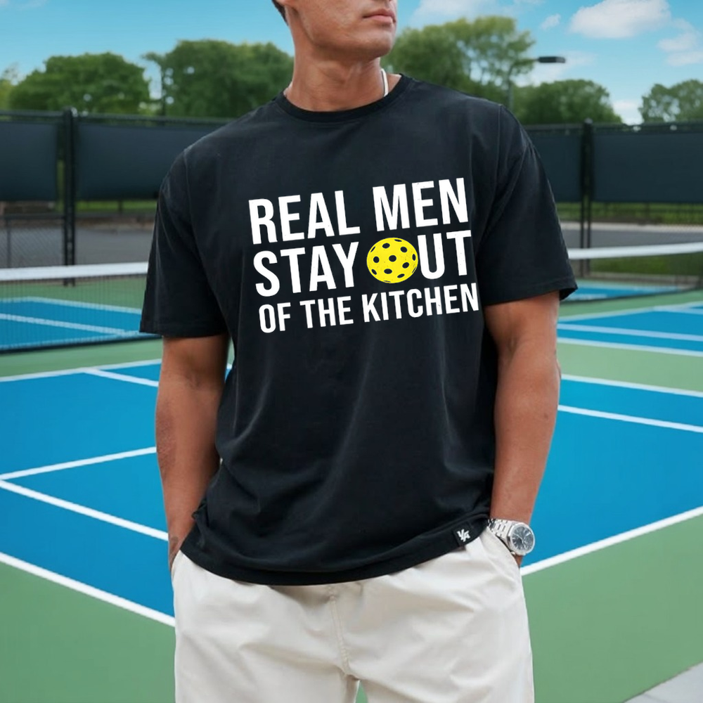 Person wearing a black t-shirt with a humorous graphic and text on a tennis court.