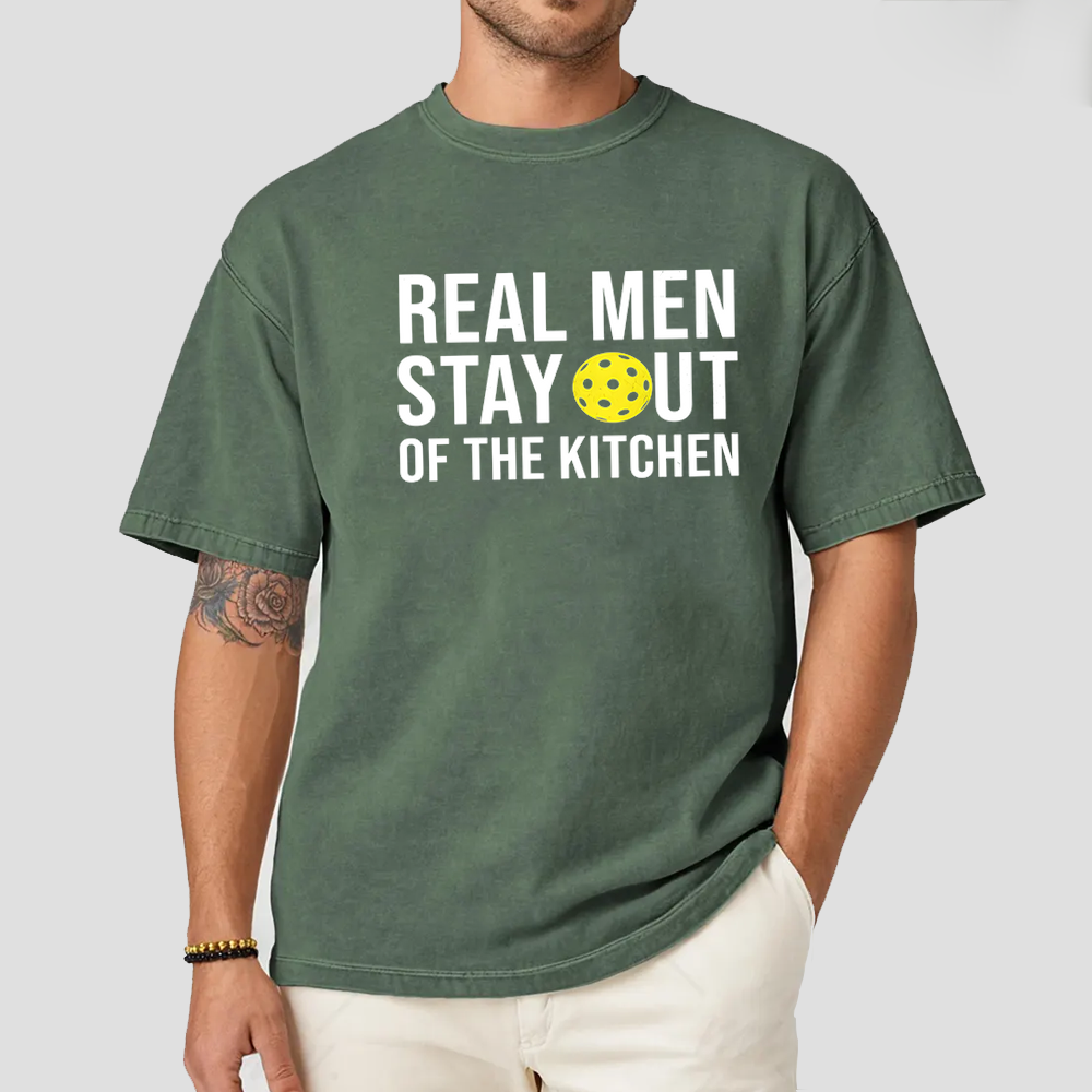 Person wearing a green t-shirt with text and a pickleball graphic.