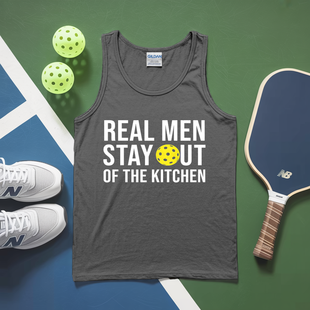 Gray tank top with 'Real Men Stay Out of the Kitchen' text, pickleball paddles, and balls on a green and blue surface.