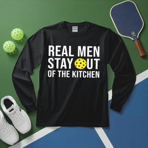 Black long-sleeve shirt with 'Real Men Stay Out of the Kitchen' text on a sports court background.