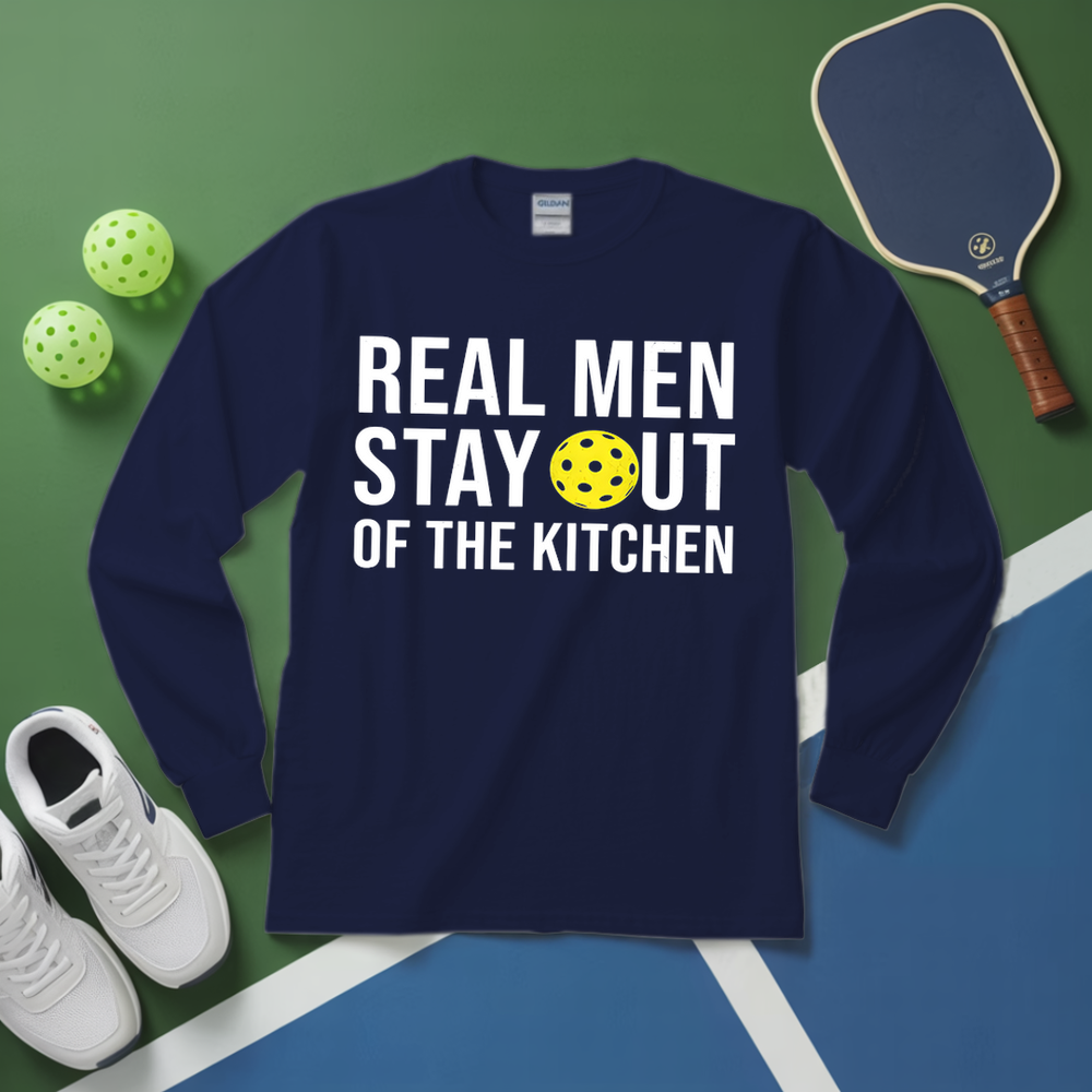 Navy blue long-sleeve shirt with humorous text on a green and blue surface with pickleball equipment.