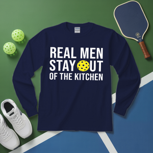 Navy blue long-sleeve shirt with humorous text on a green and blue surface with pickleball equipment.