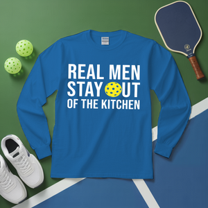 Blue long-sleeve shirt with text and pickleball equipment on a green and blue surface