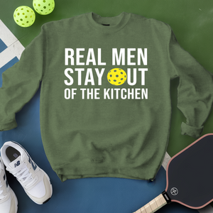 Green sweatshirt with text and pickleball equipment on a green and blue background