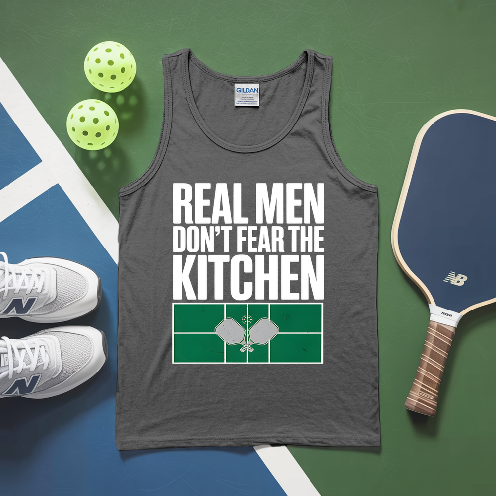 Gray tank top with 'Real men don't fear the kitchen' text, pickleball paddles, and balls on a green and blue surface.