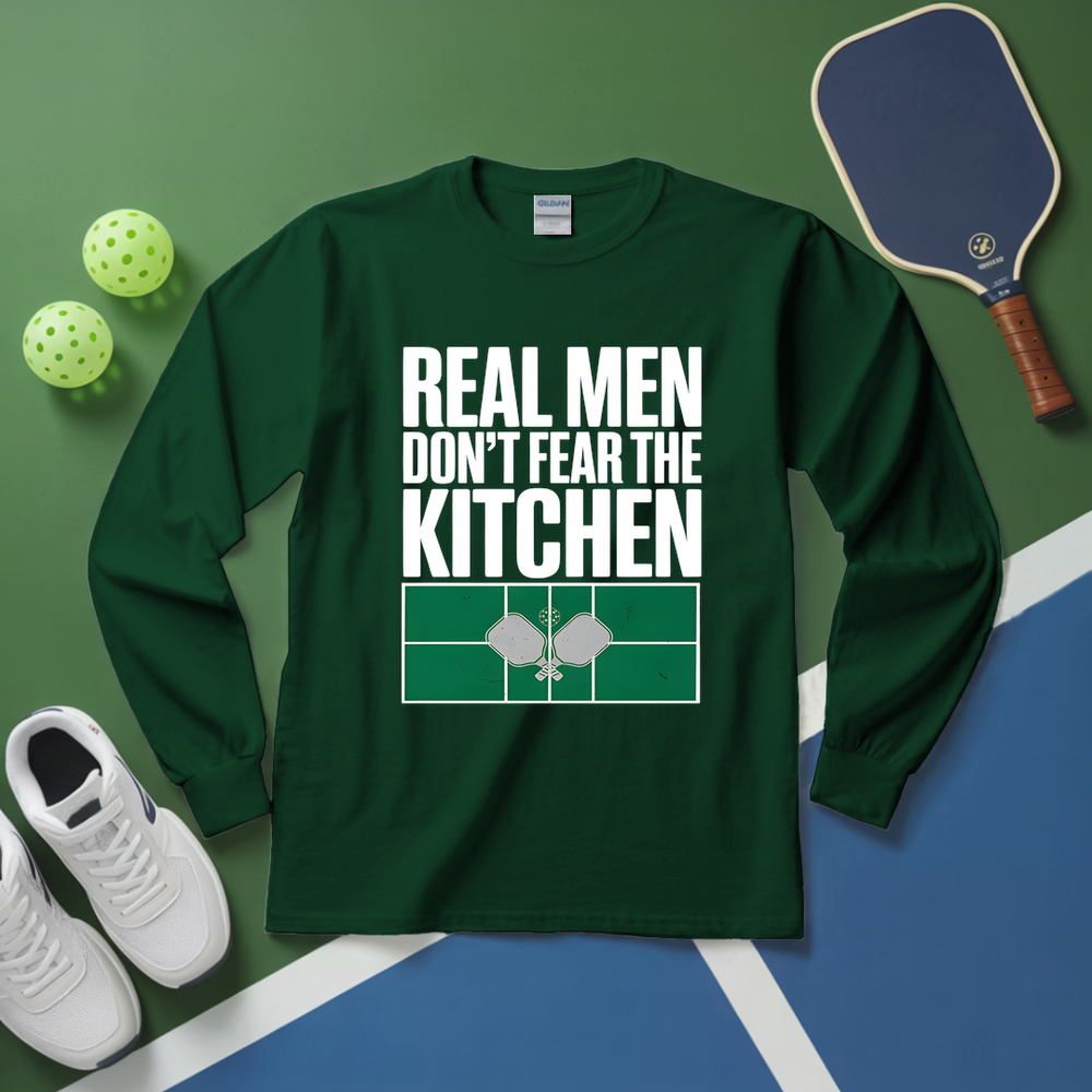 Green long-sleeve shirt with 'Real men don't fear the kitchen' text on a green and blue background with sports equipment.