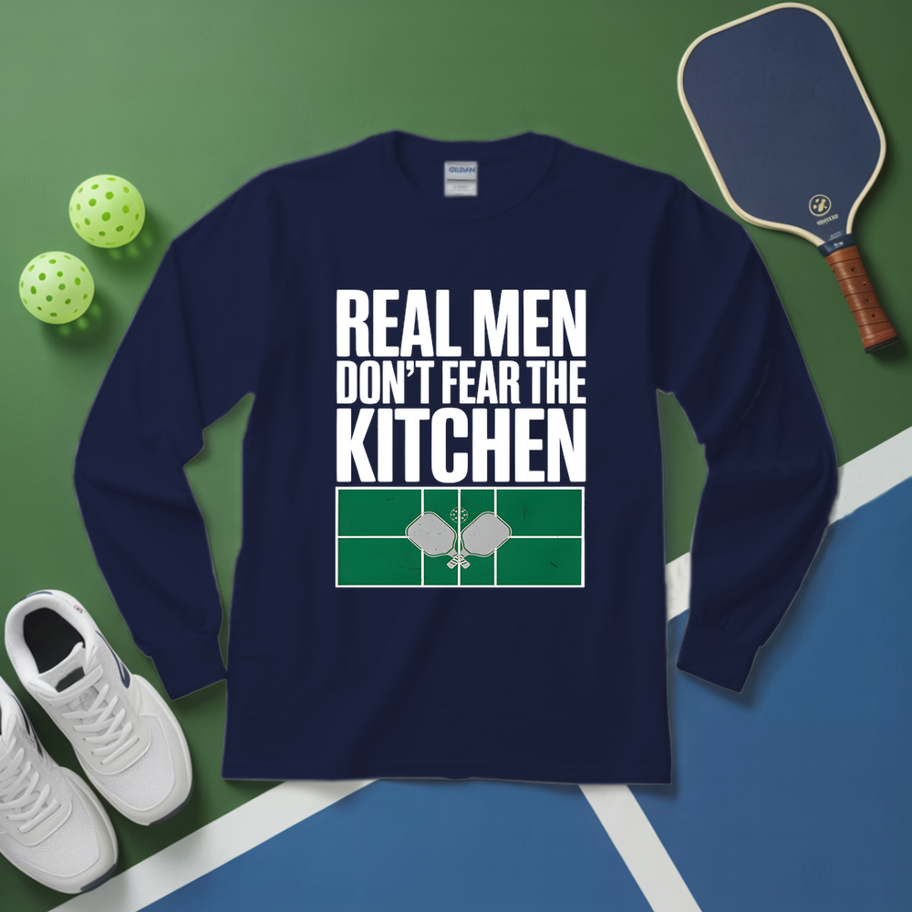 Navy blue sweatshirt with 'Real men don't fear the kitchen' text on a green and blue background with pickleball equipment.