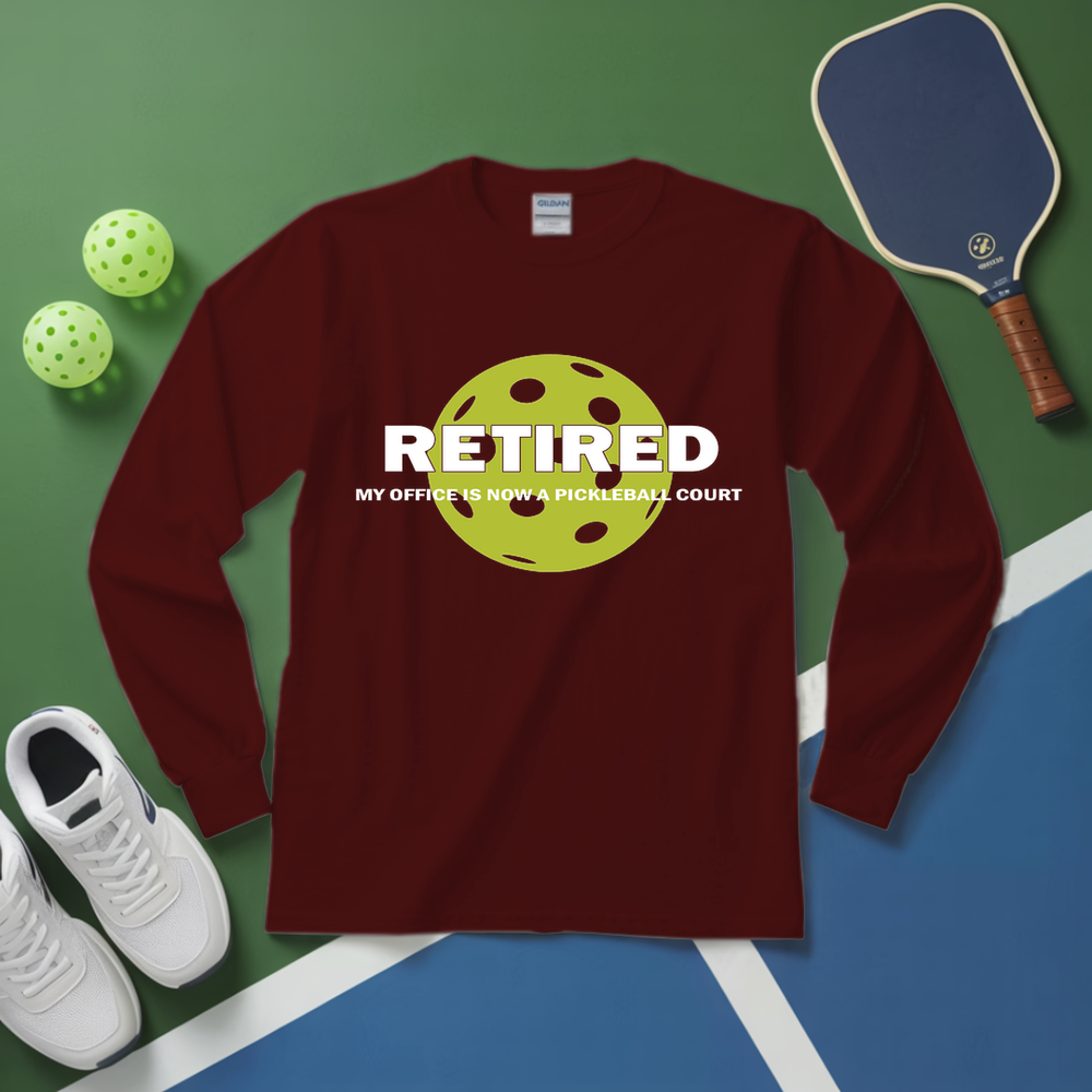Maroon long-sleeve shirt with pickleball design and text on a green and blue surface with pickleball equipment.