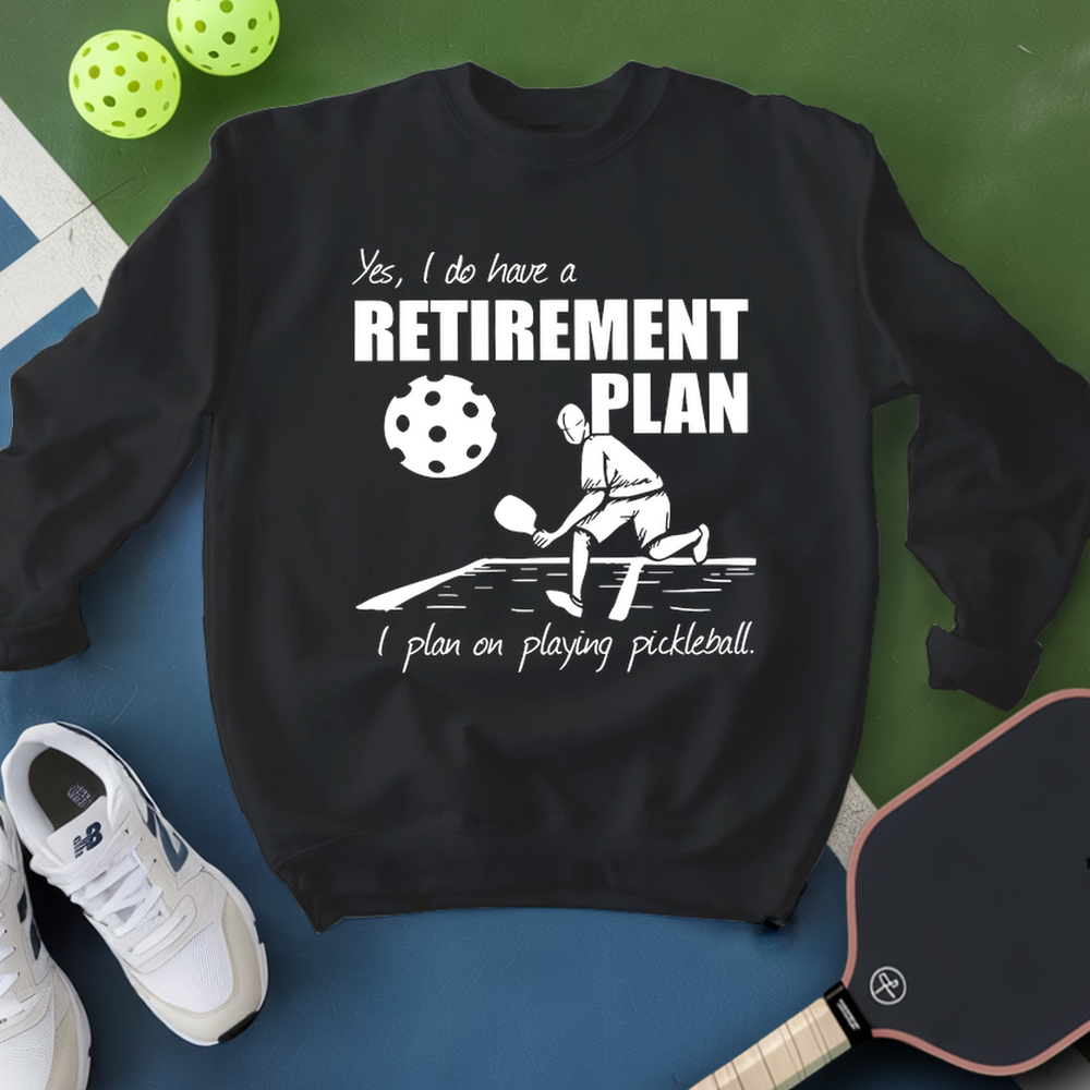 Black sweatshirt with pickleball-themed design on a blue and green background