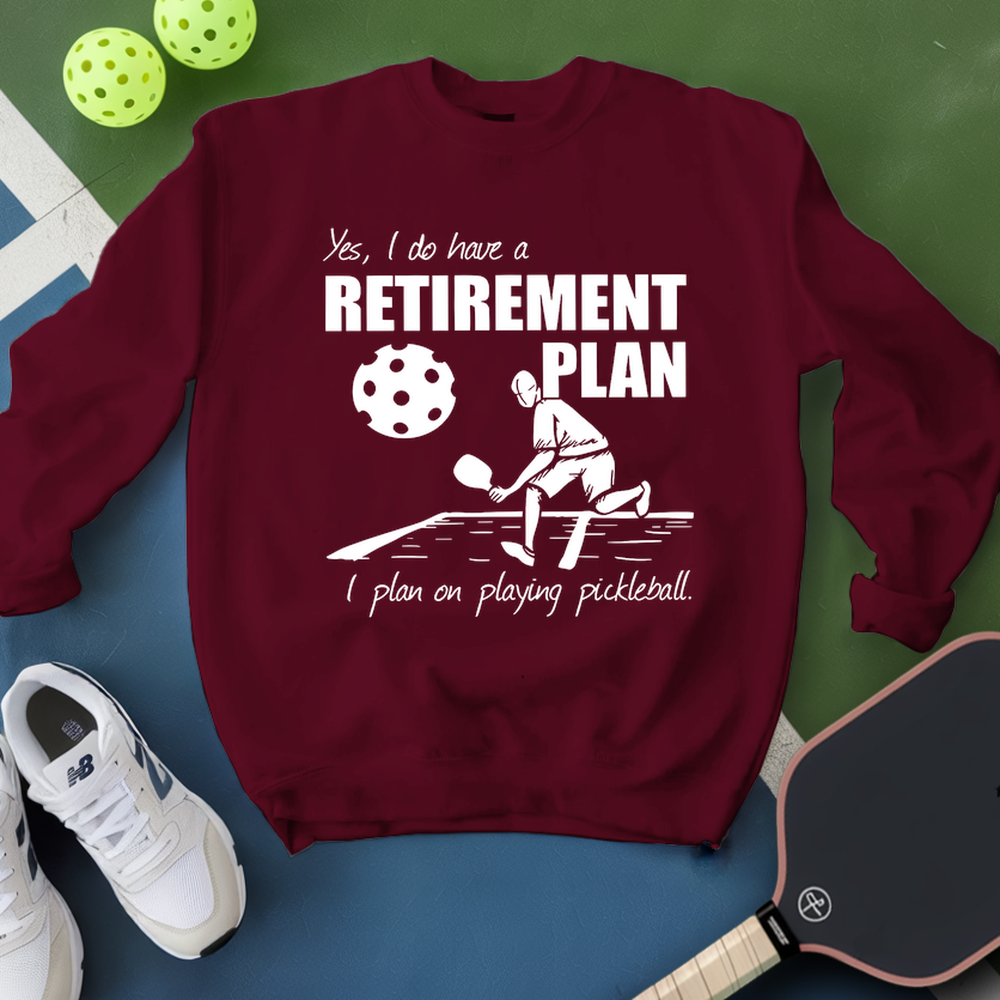 Maroon sweatshirt with pickleball-themed design on a green and blue background