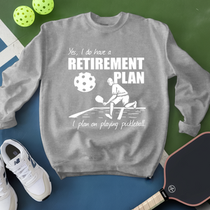 Gray sweatshirt with pickleball-themed design on a green and blue background