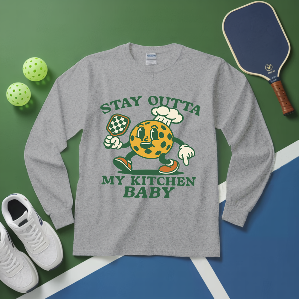 Gray long-sleeve shirt with cartoon character and text on a green and blue background with sports equipment.