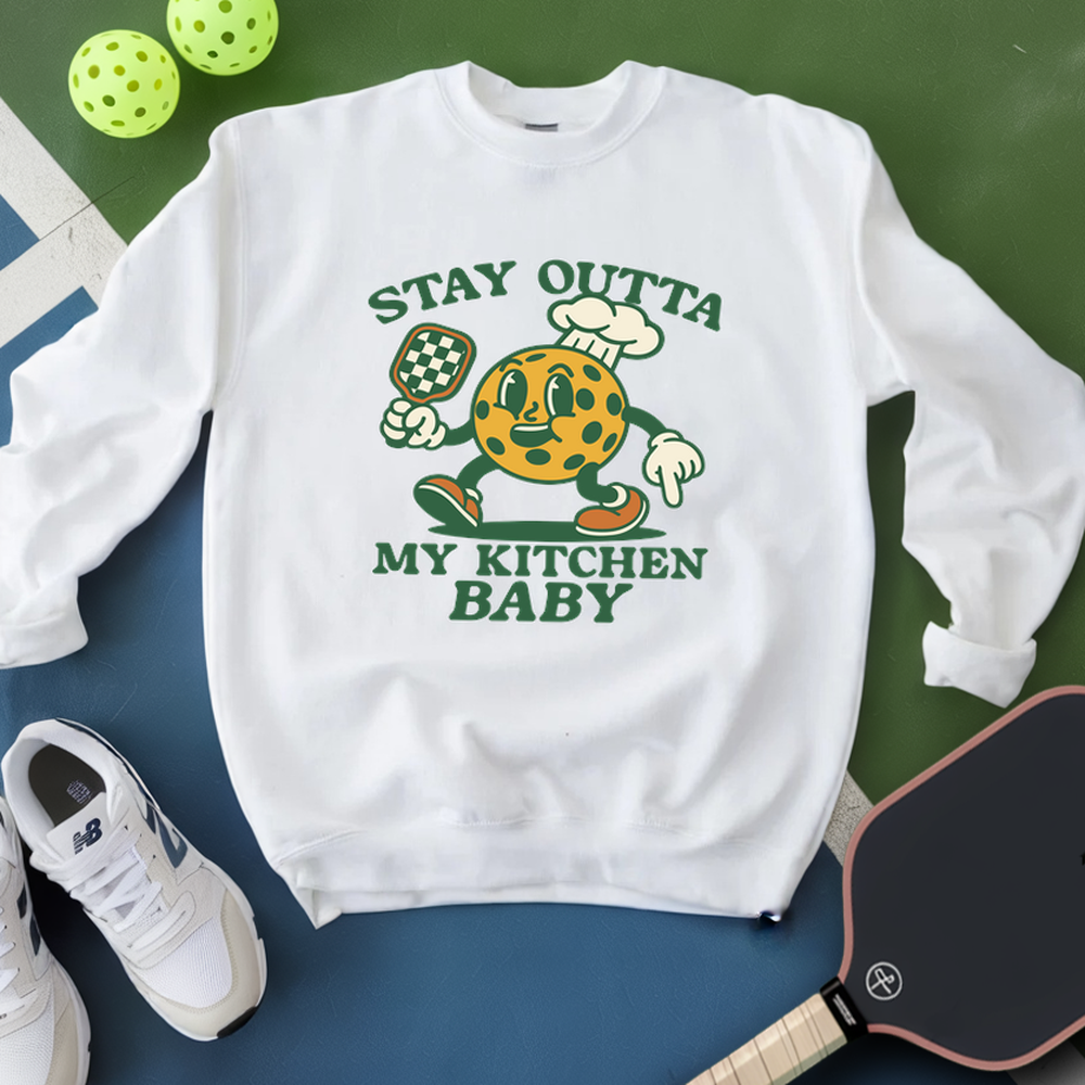 White sweatshirt with cartoon character and text on a green and blue background