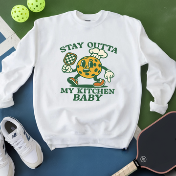 White sweatshirt with cartoon character and text on a green and blue background
