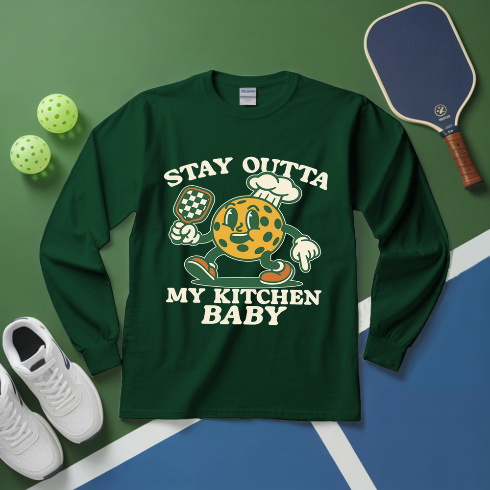 Green long-sleeve shirt with cartoon character and text on a green and blue background with sports equipment.