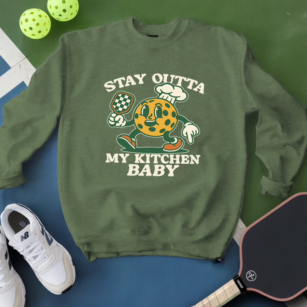 Green sweatshirt with cartoon character and text on a green and blue background with sports equipment.
