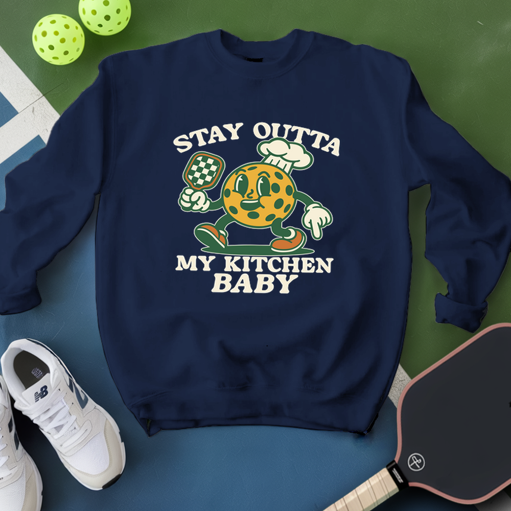 Navy blue sweatshirt with graphic design and text, placed on a green and blue surface with sports equipment.