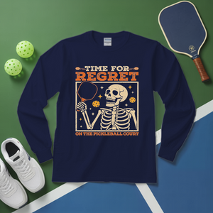 Navy blue long-sleeve shirt with skeleton graphic and text on a green and blue surface with pickleball equipment.
