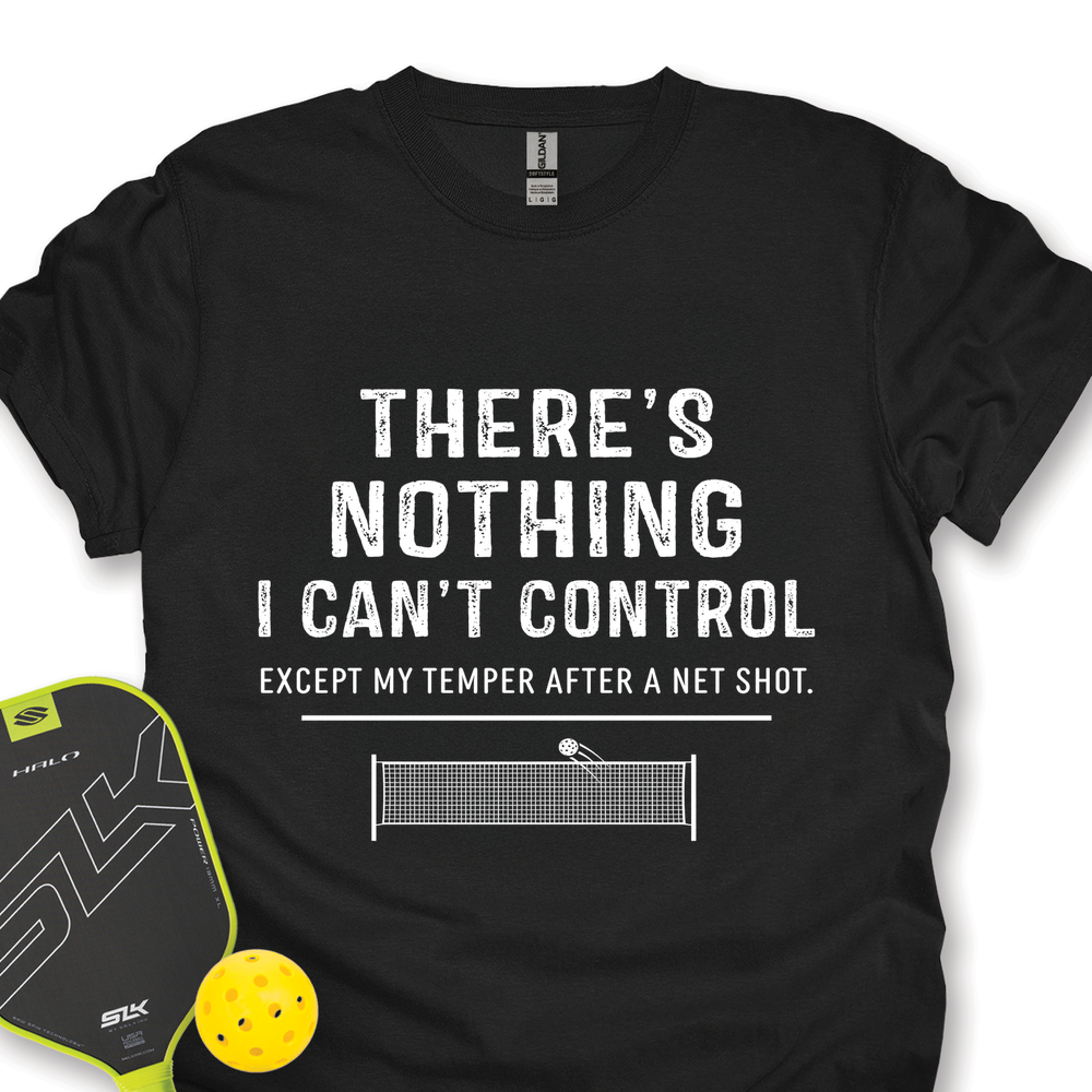 Black t-shirt with humorous pickleball quote and paddle and ball for scale on a white background