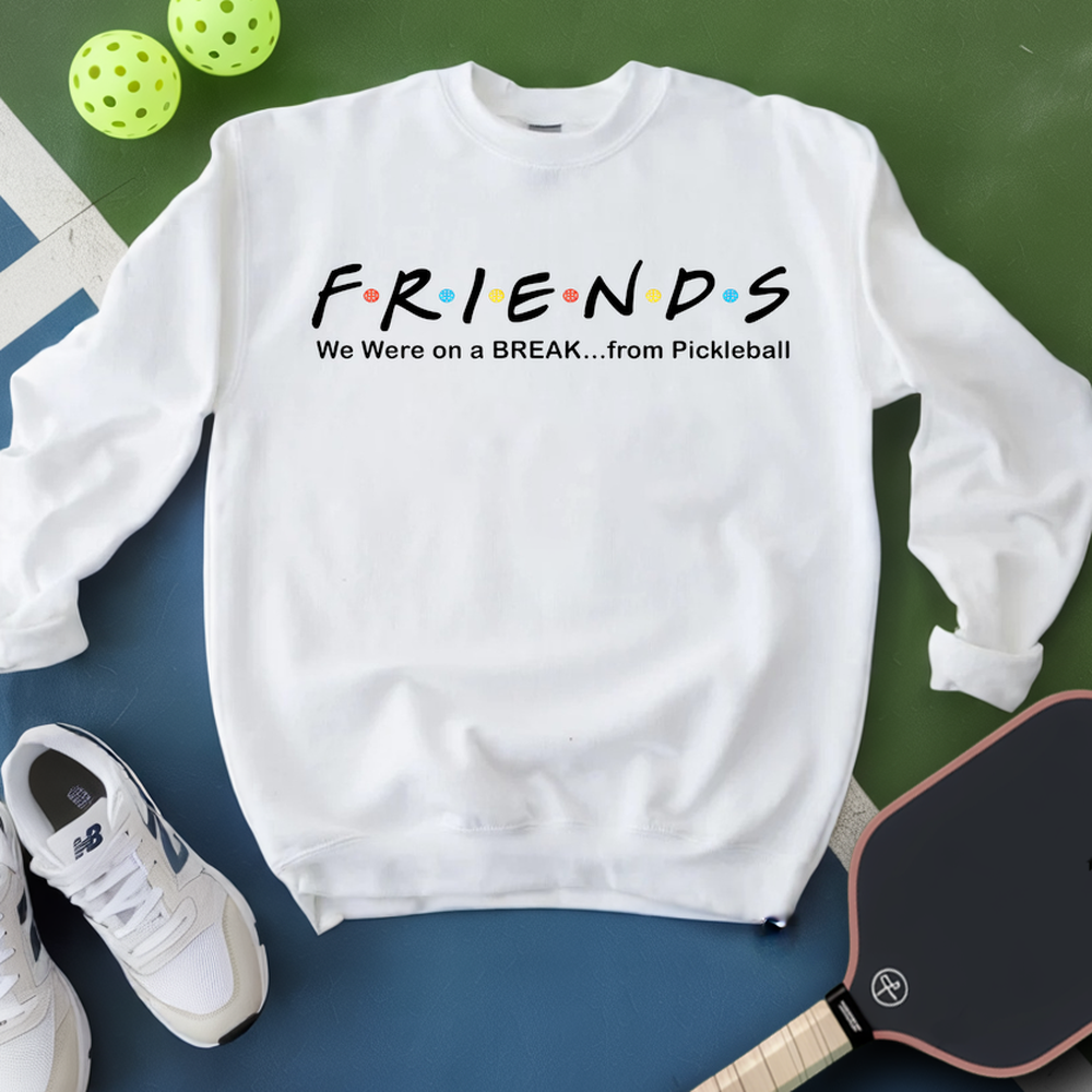 White sweatshirt with 'FRIENDS' design and pickleball equipment on a green and blue background