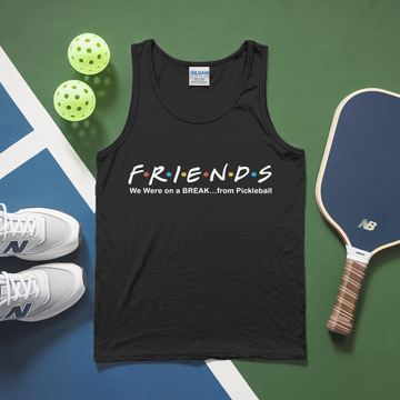 Black tank top with 'Friends' text on a pickleball court with balls and paddle.