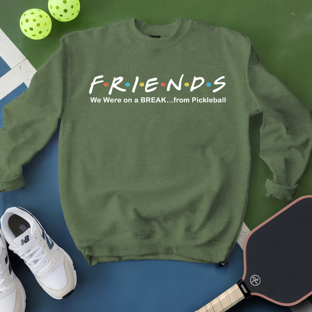 Green sweatshirt with 'FRIENDS' text, pickleball paddles, and balls on a green and blue background