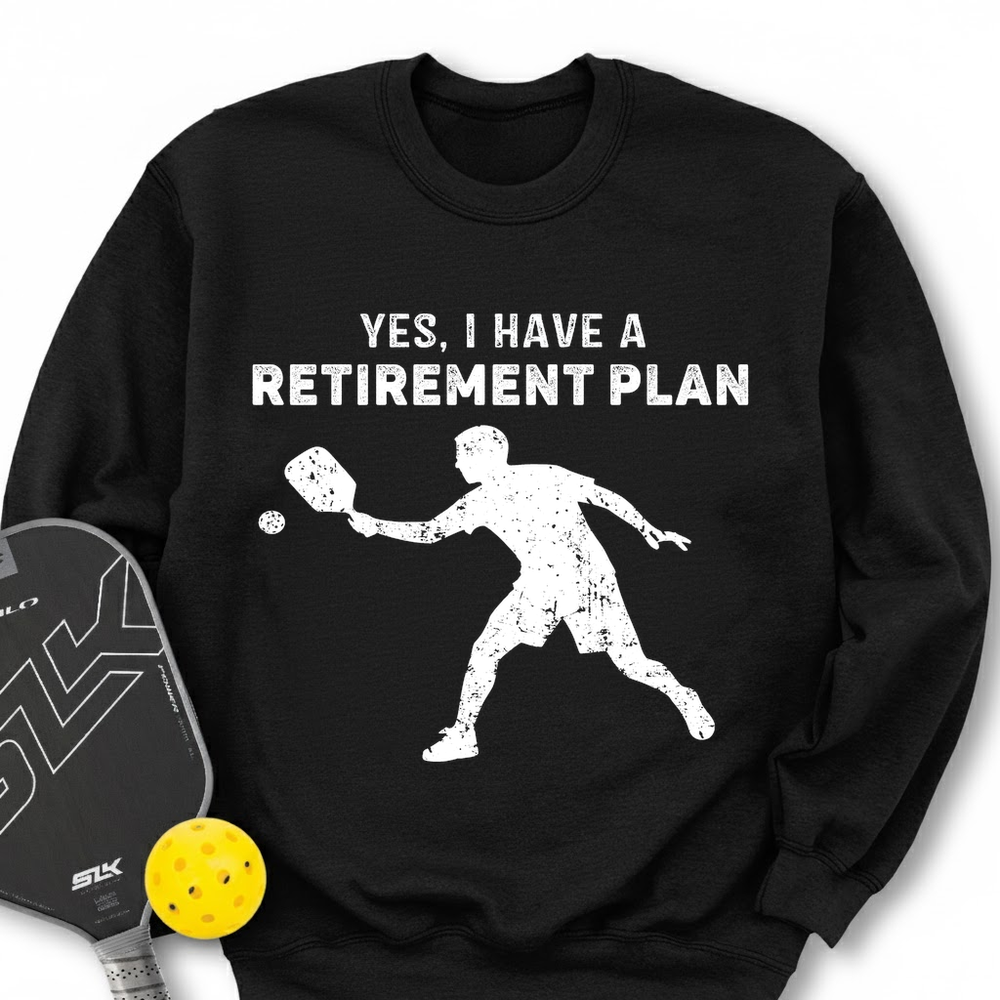 Black sweatshirt with pickleball design and text 'YES, I HAVE A RETIREMENT PLAN' on a white background.
