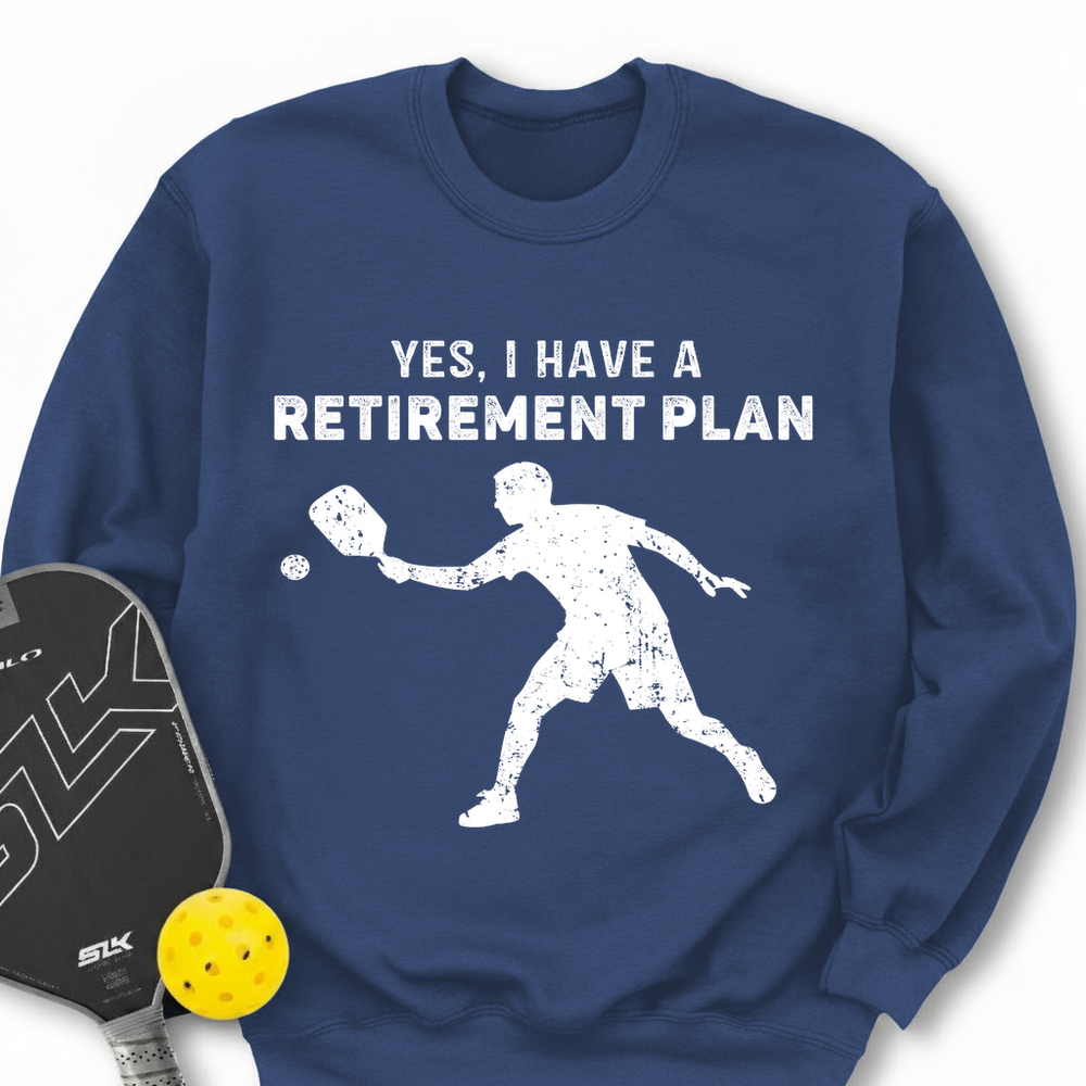 Blue sweatshirt with pickleball-themed design and paddle and ball on a white background
