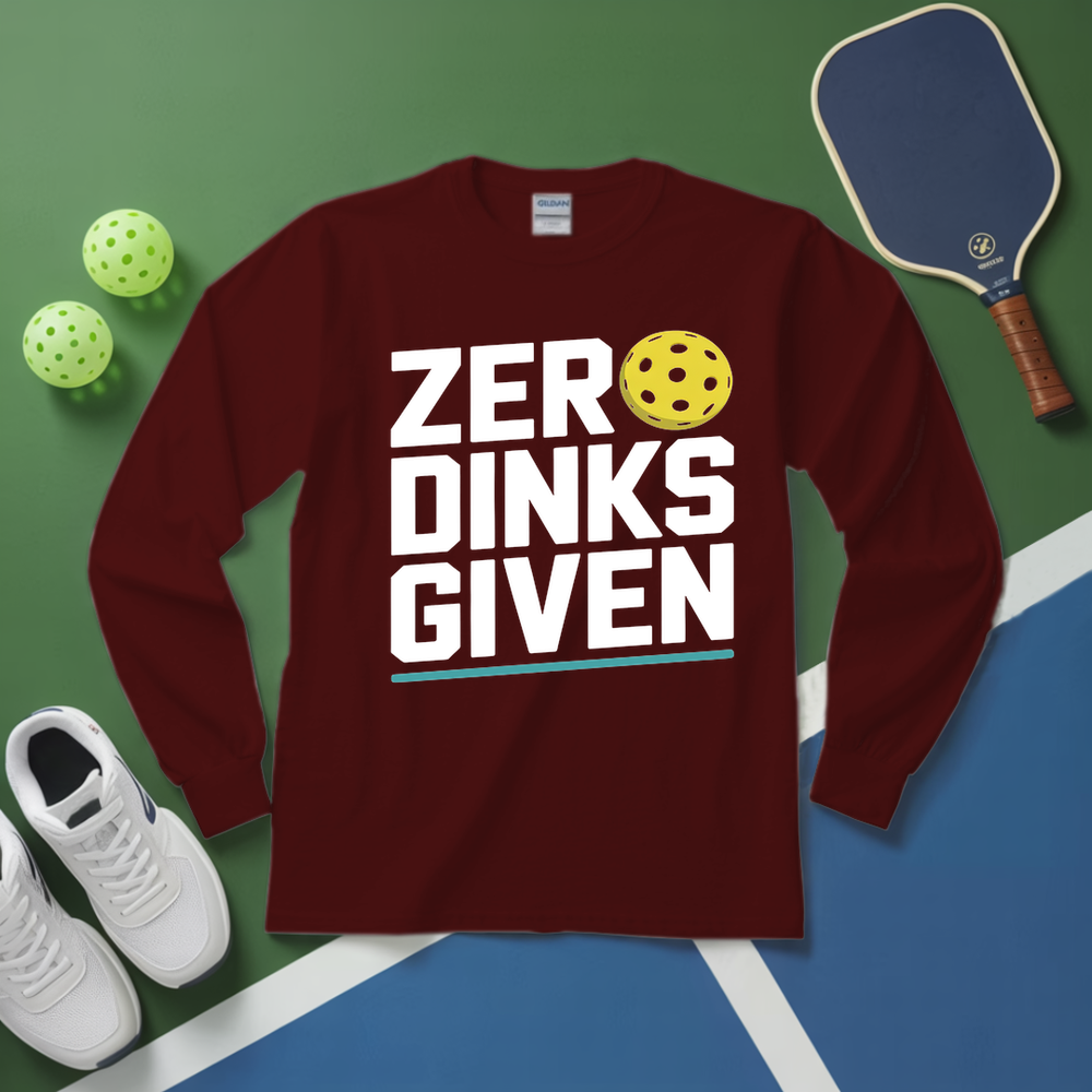 Maroon long-sleeve shirt with 'ZER DINKS GIVEN' text and pickleball elements on a green and blue surface.
