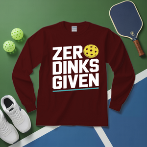 Maroon long-sleeve shirt with 'ZER DINKS GIVEN' text and pickleball elements on a green and blue surface.