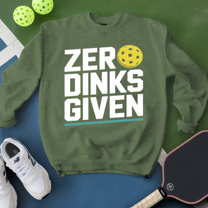 Green sweatshirt with 'ZER DINKS GIVEN' text, pickleball paddles, and balls on a green and blue background