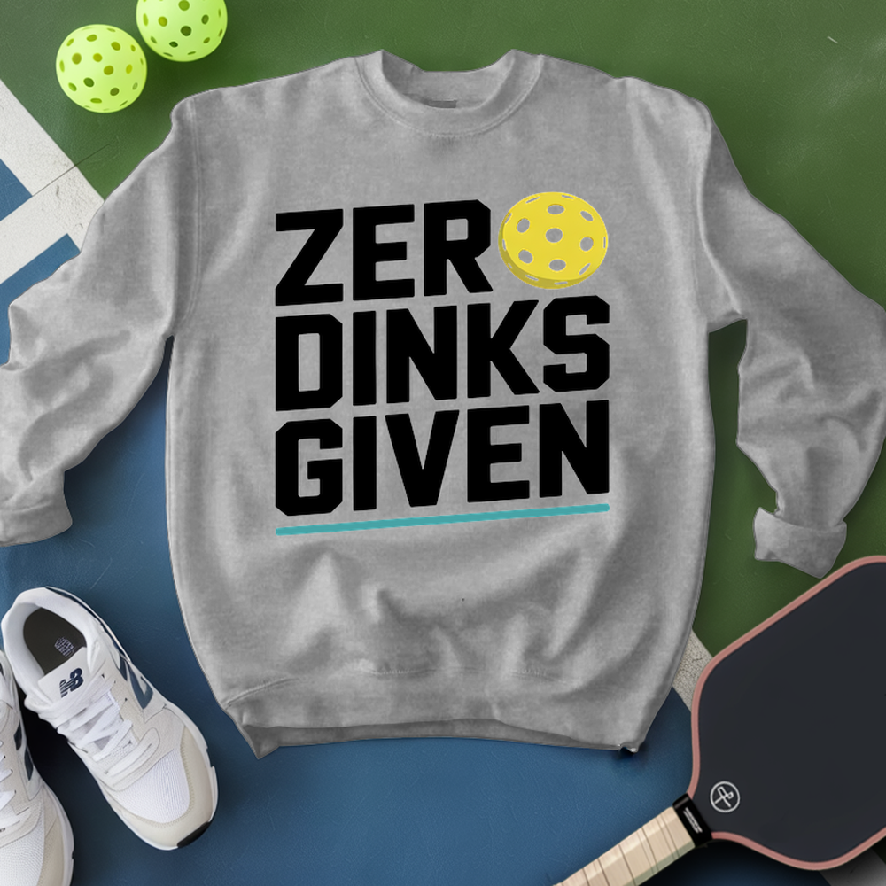Gray sweatshirt with 'ZER DINKS GIVEN' text, pickleball balls, paddle, and shoes on a green and blue background