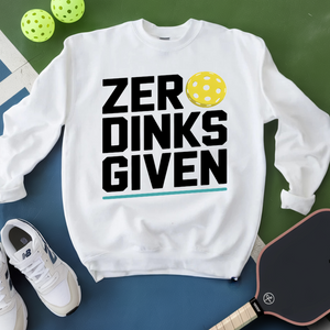 White sweatshirt with 'ZER DINKS GIVEN' text and pickleball elements on a green and blue background.