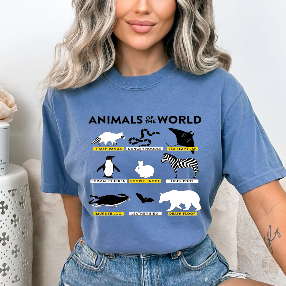 Person wearing a blue t-shirt with 'Animals of the World' graphic design.