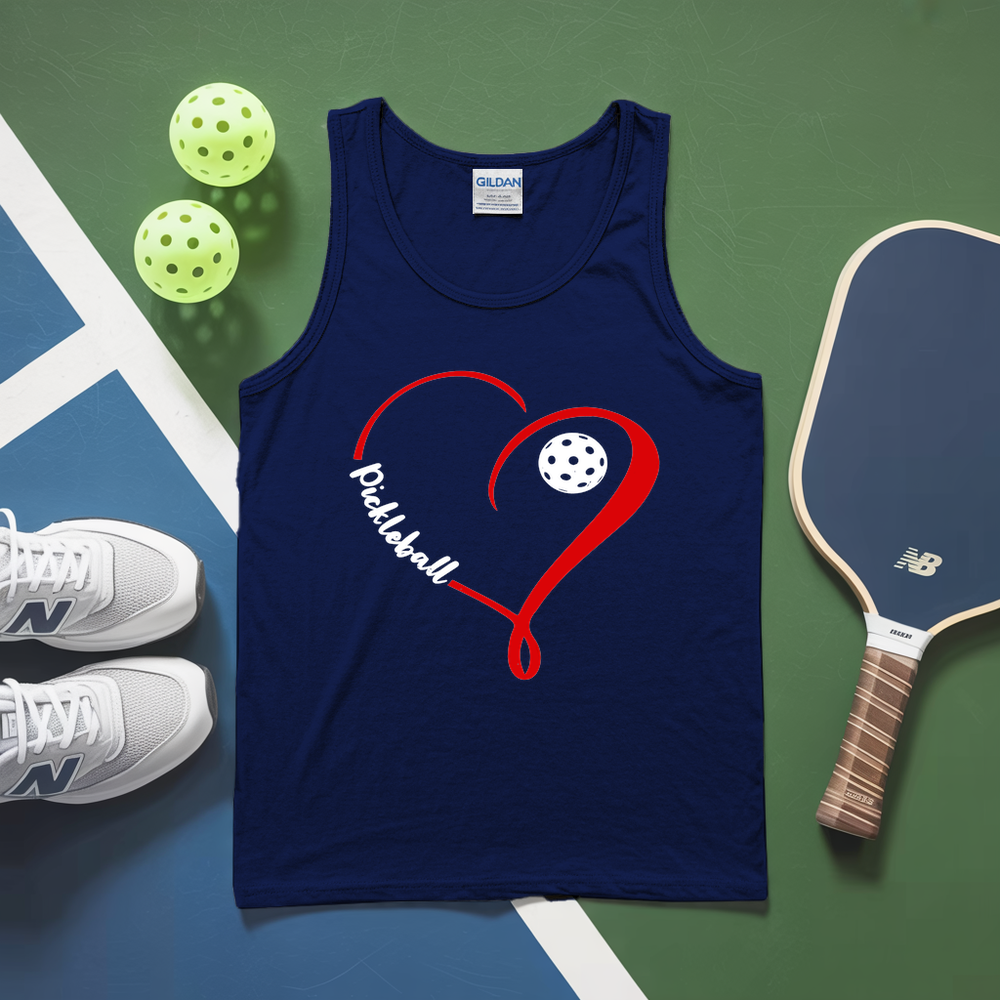 Blue tank top with pickleball design on a green and blue surface with pickleballs and a paddle.
